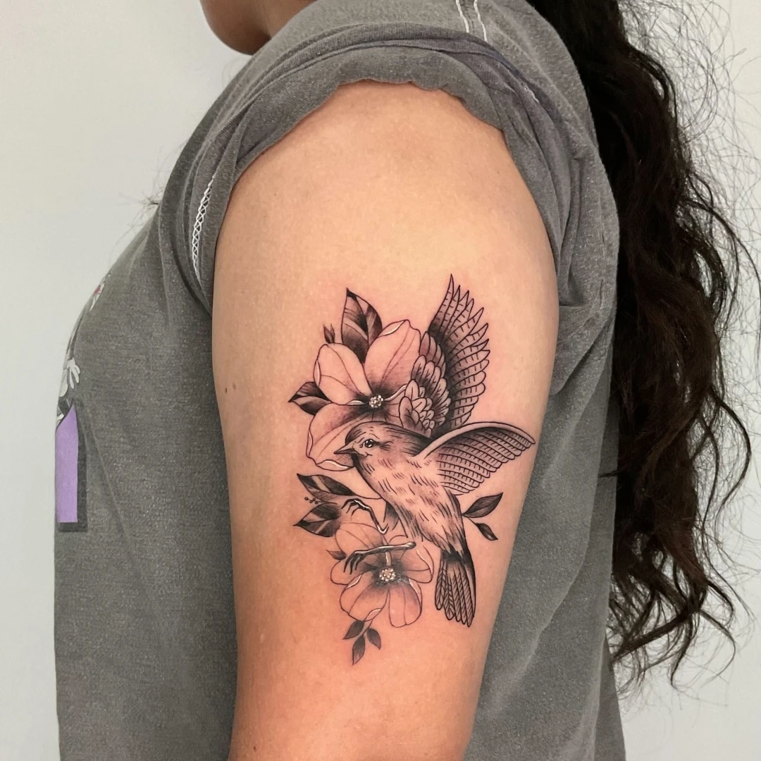 Detailed tattoo of a bird on a person's arm