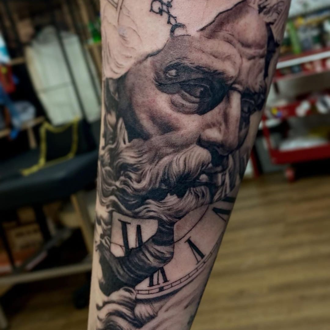 Intricate tattoo design featuring an elderly man and clock elements.