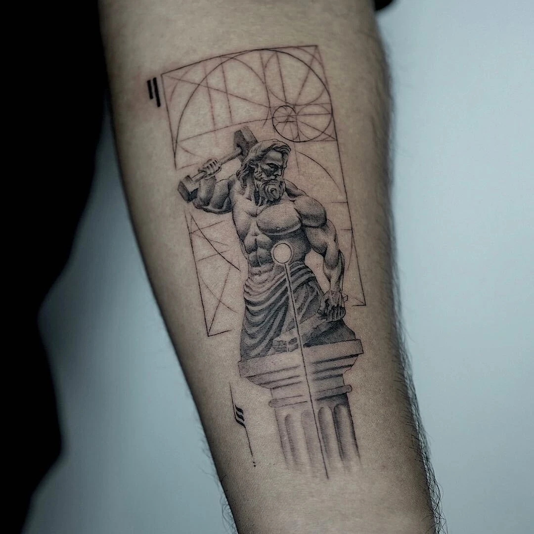 Intricate tattoo of a muscular figure holding a hammer.