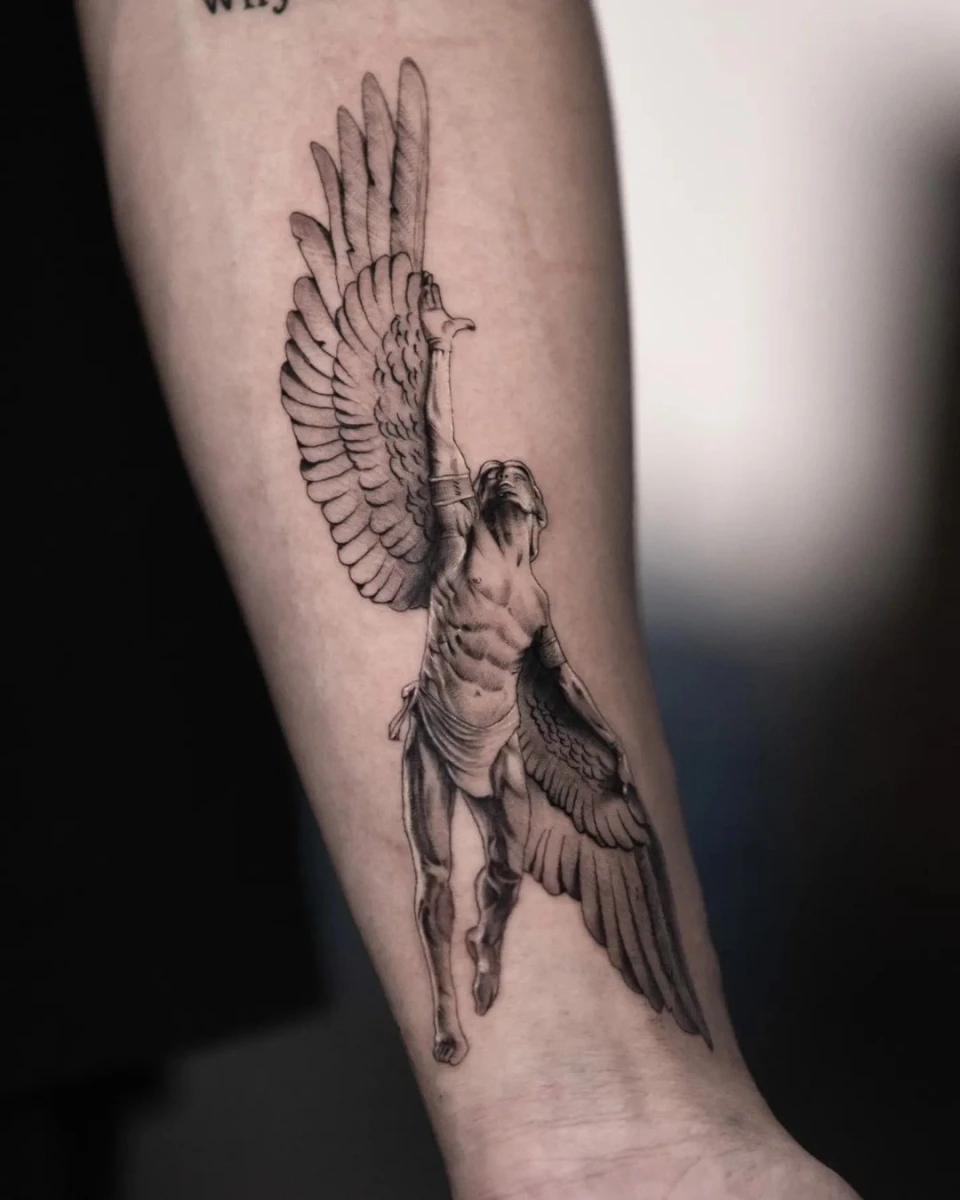 Detailed tattoo of a winged figure on a forearm