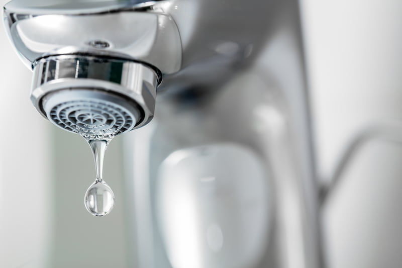 Close-up of a water faucet dripping