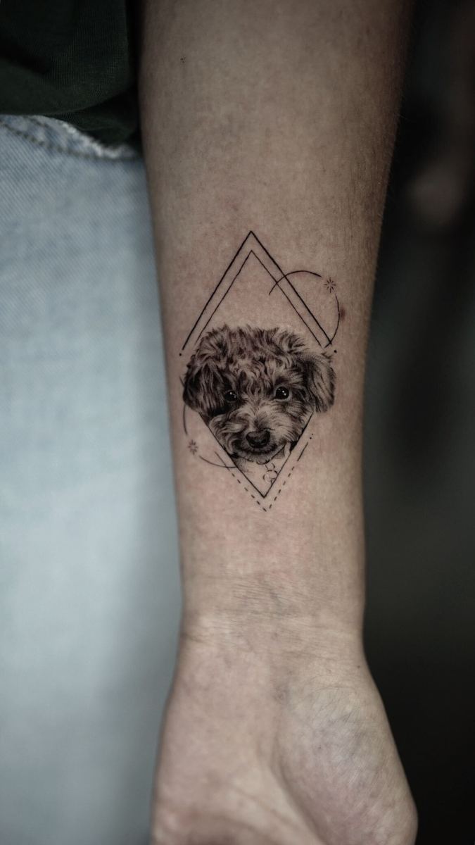 Detailed tattoo of a dog's face within geometric patterns