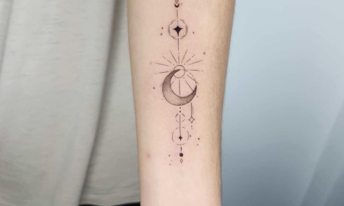 Black and grey moon tattoo on arm