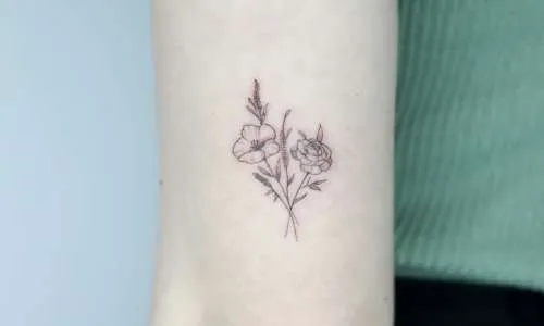 Delicate floral tattoo on a person's arm