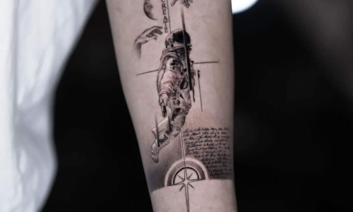 Detailed tattoo of an astronaut on a forearm