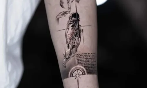 Detailed tattoo of an astronaut on a forearm