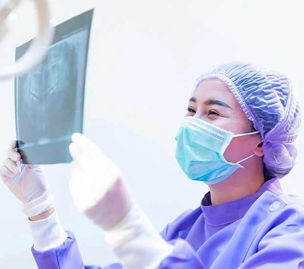 Medical professional analyzing X-ray image