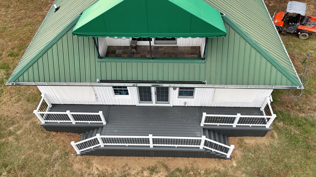 Aerial view of a green-roofed house with a deck