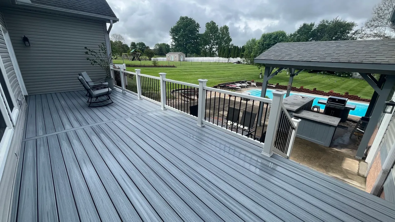 Inviting deck view with pool and backyard greenery