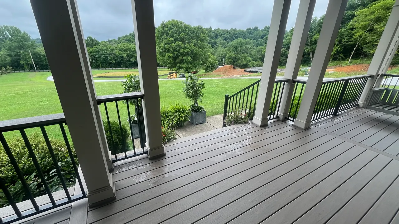 Covered porch view overlooking a lush green landscape