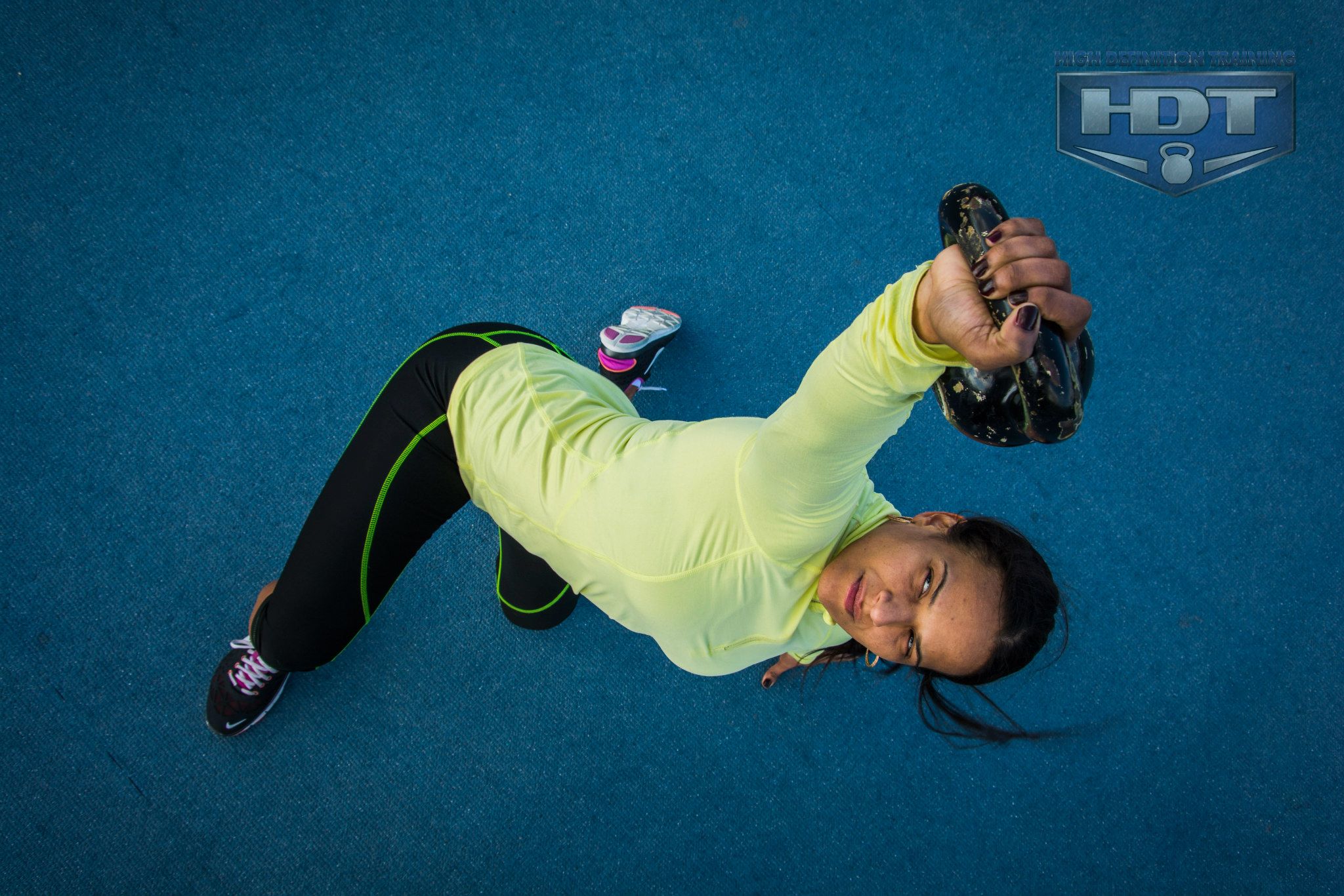 Woman exercising with a kettlebell indoors