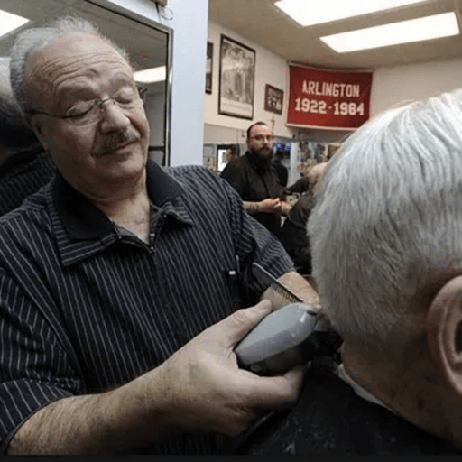 Barber cutting a client's hair in a salon