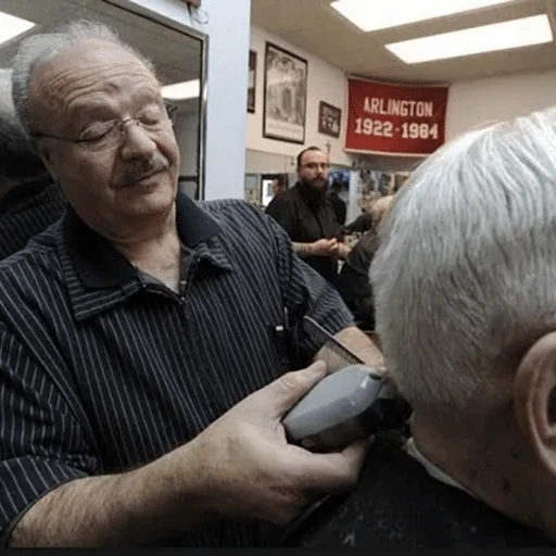 Barber cutting a client's hair in a salon