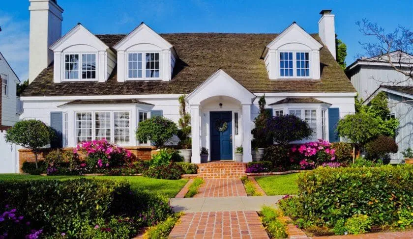 Charming house with landscaping and flowers