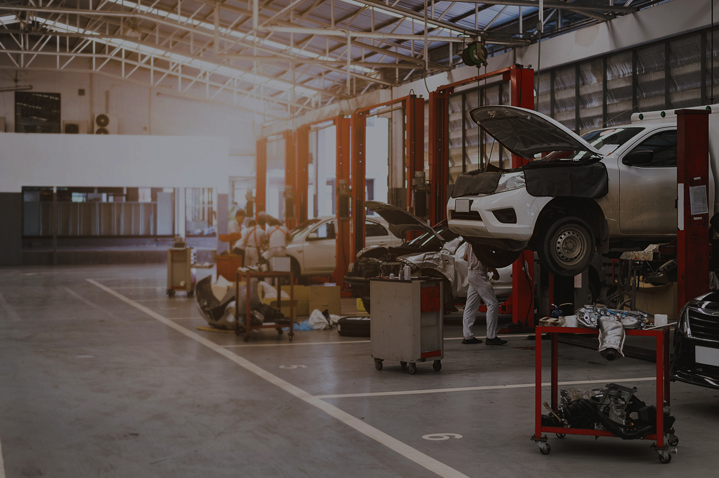 Auto repair shop with mechanics working on vehicles