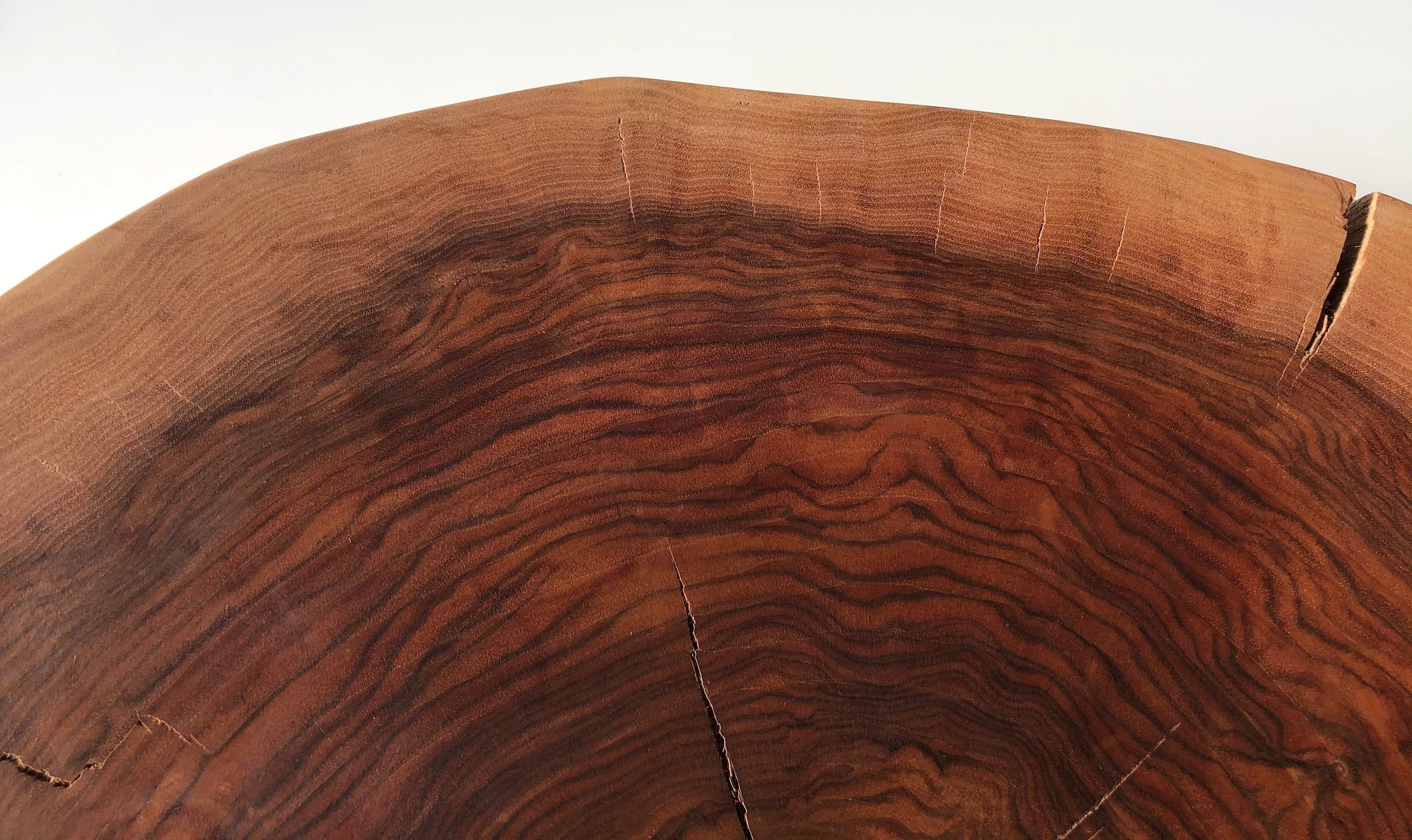 Close-up of a wooden tree stump showing rich grain patterns