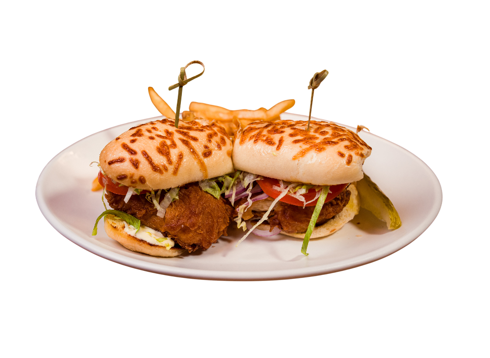 Two chicken sandwiches with crispy fried chicken and toppings