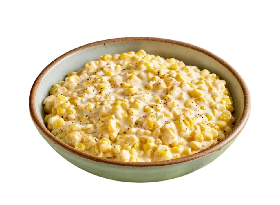 Bowl of creamy corn dish with pepper
