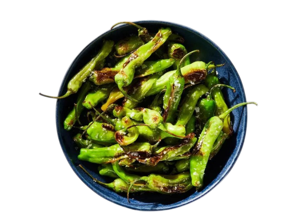 A bowl of roasted green peppers on a black background.