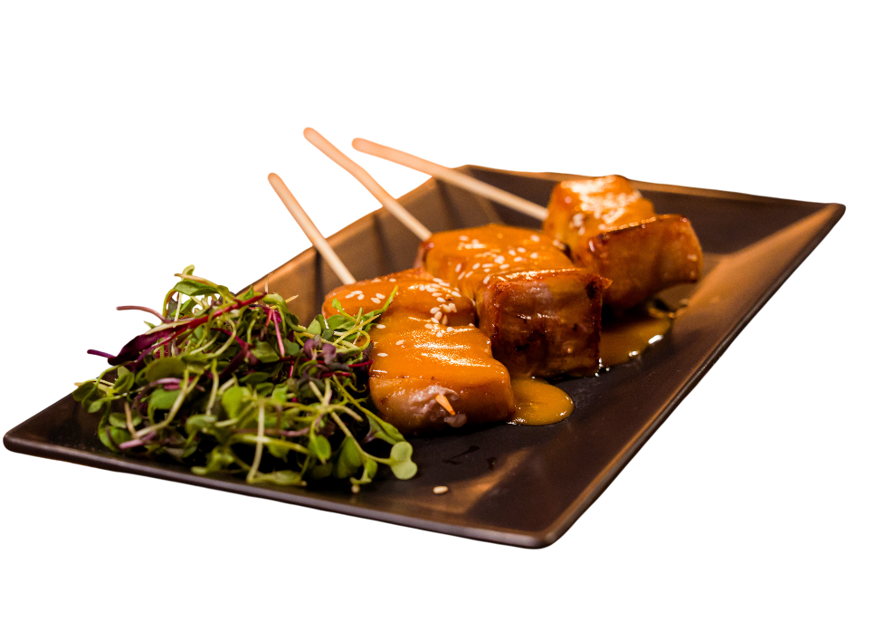 Delicious skewers of meat with sauce and salad on plate