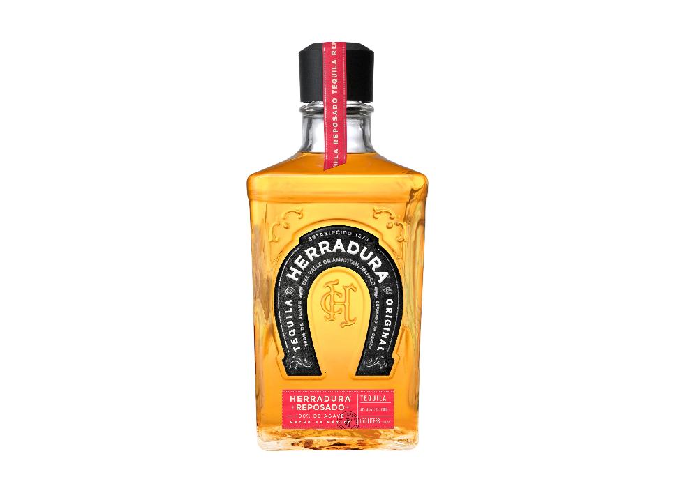 Bottle of Herradura Reposado tequila on a black background