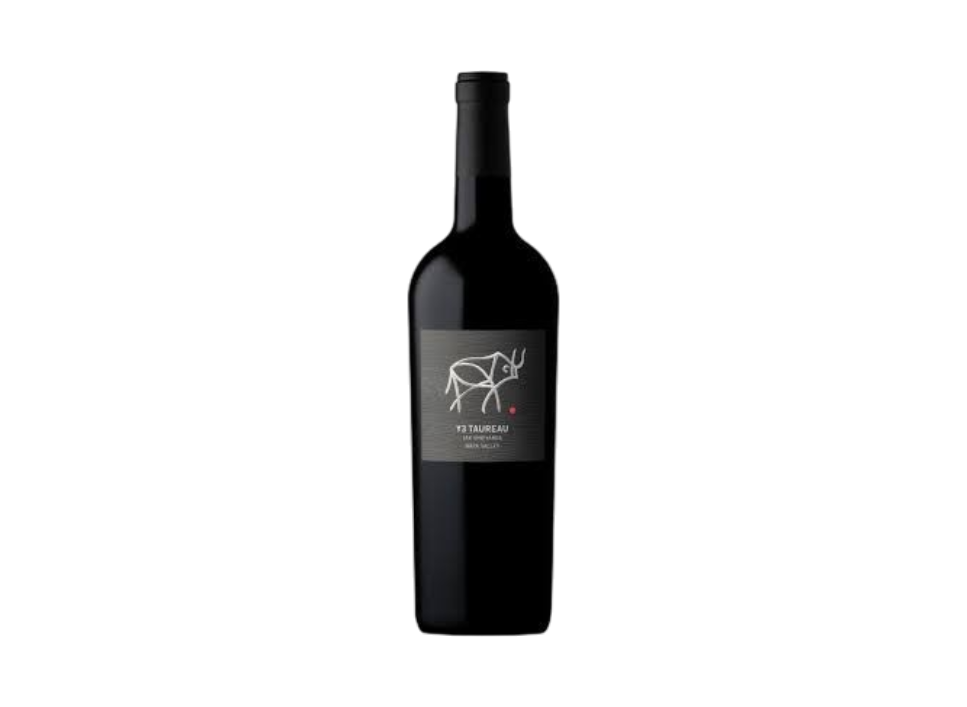 A dark bottle of red wine with a minimalist label featuring a white line drawing of a cow, set against a black background.