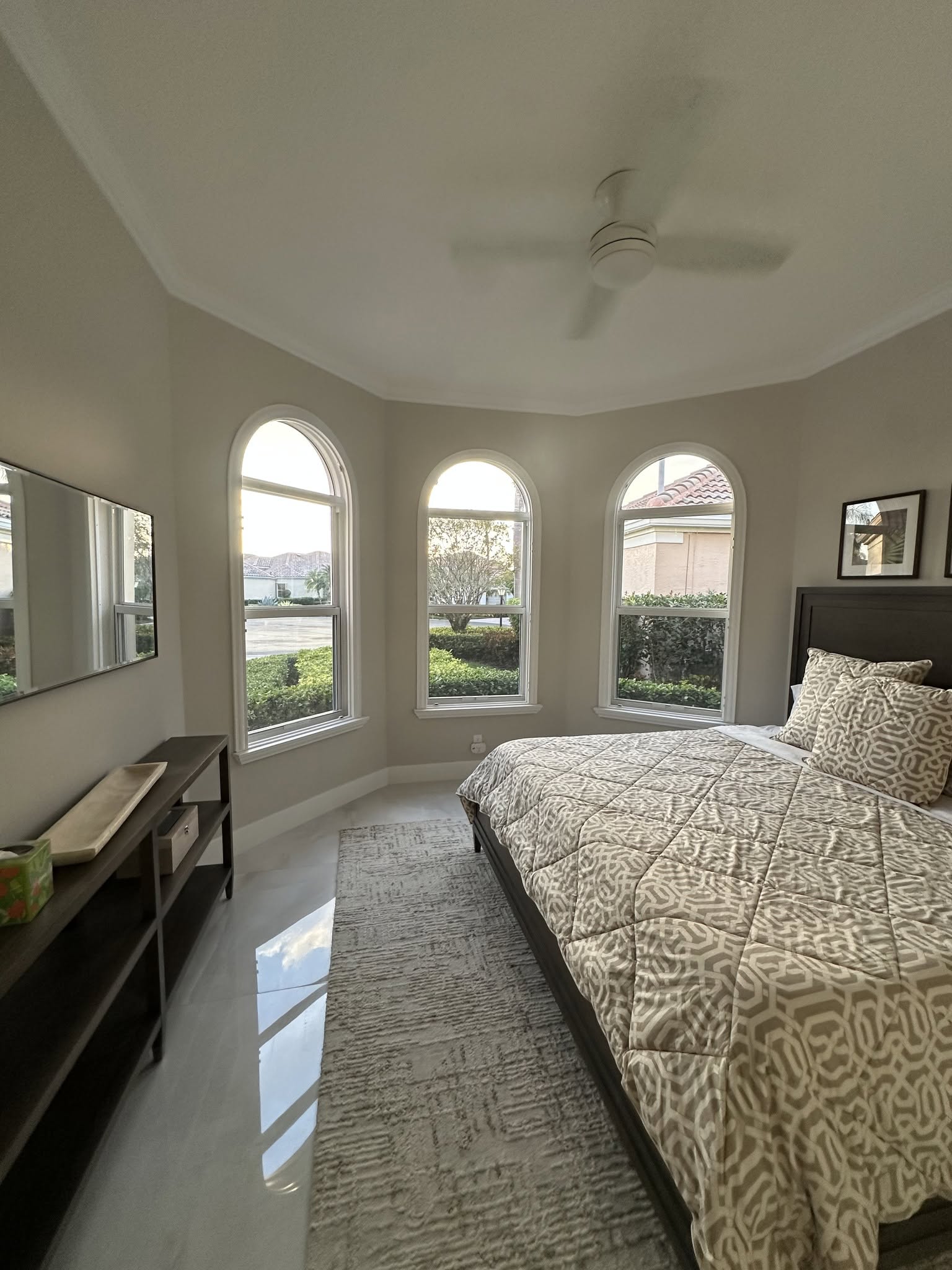 Modern bedroom with large windows and cozy decor