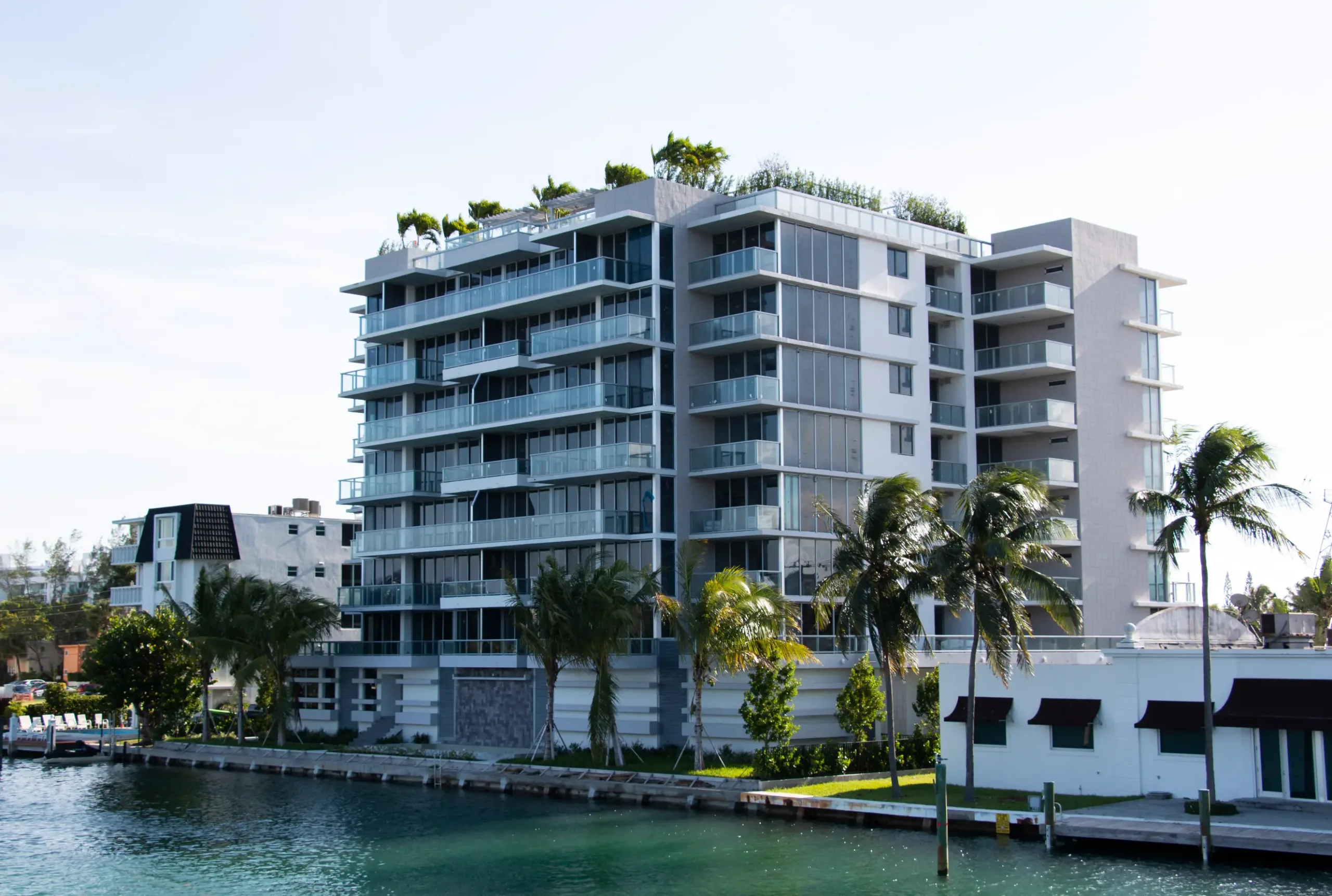 Modern waterfront building with palm trees