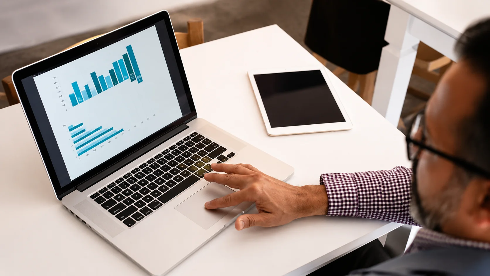 Business professional analyzing data on a laptop