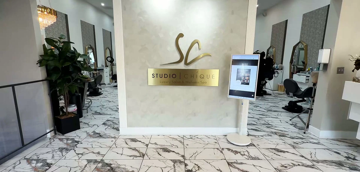 Interior view of Studio Chicque, a luxury beauty spa with marble flooring and elegant decor.