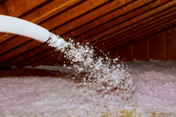 Insulation installation in an attic with spray material