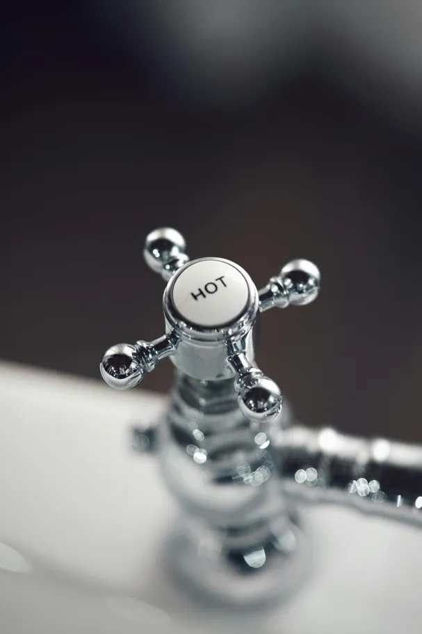 Close-up of a chrome hot water faucet