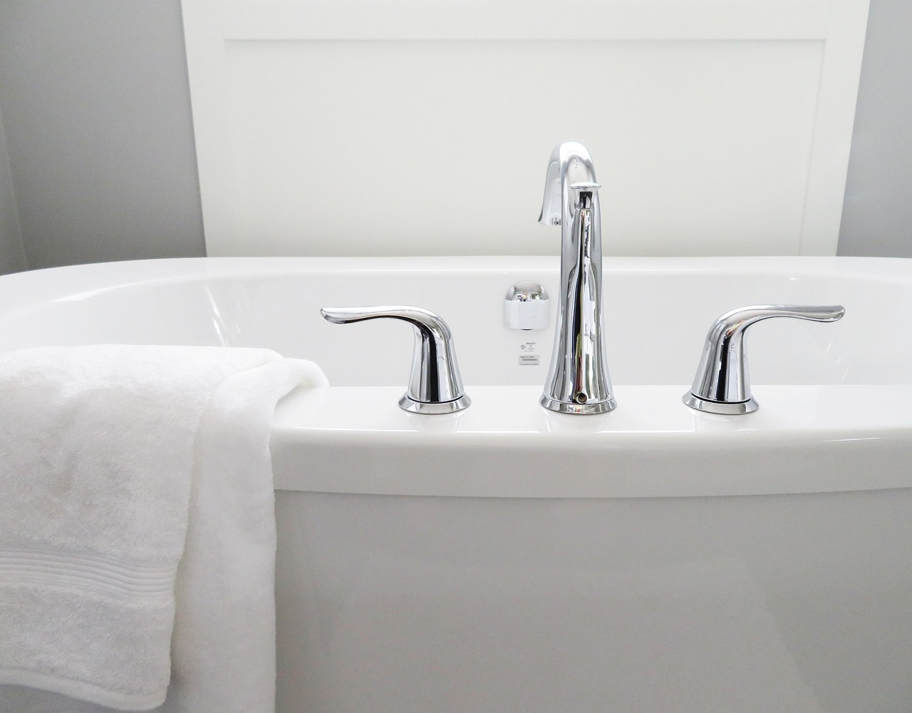 Modern bathroom faucet and towel on a bathtub