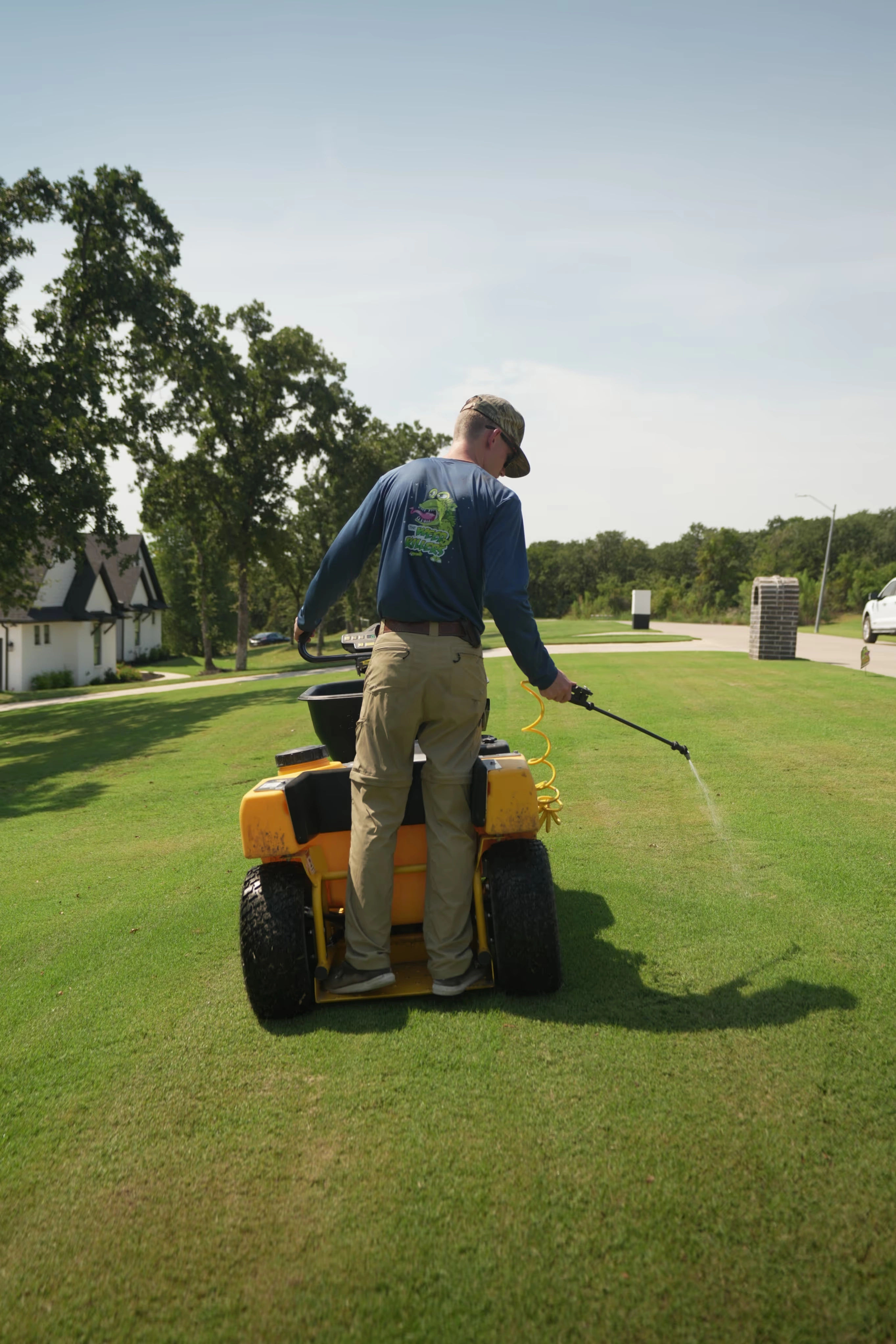Man using a spray treatment machine on a lawn