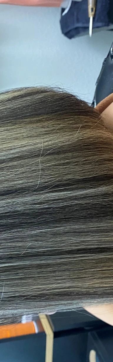 Woman with highlighted bob hairstyle in salon