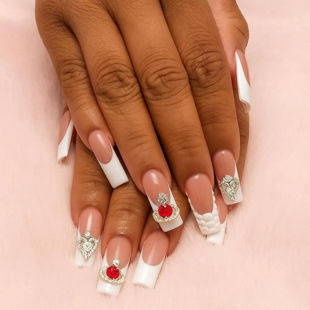 Elegant French manicure with red and silver nail art embellishments