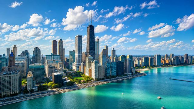 Aerial view of Chicago skyline beside Lake Michigan.