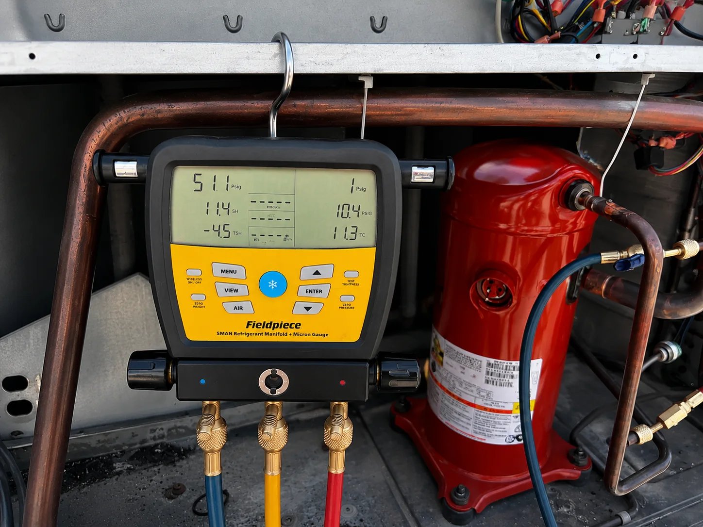 Digital manifold gauge measuring HVAC system pressure