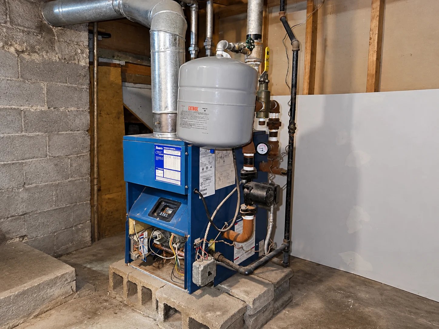 Hydronic heating boiler system in a basement
