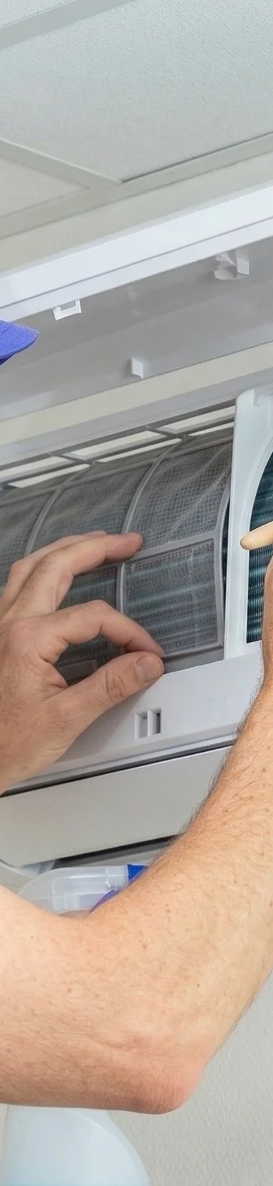 Technician performing maintenance on air conditioner