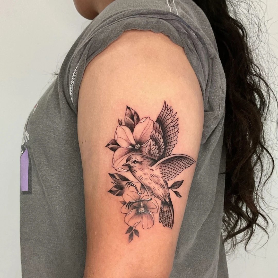 Detailed tattoo of a bird on a person's arm
