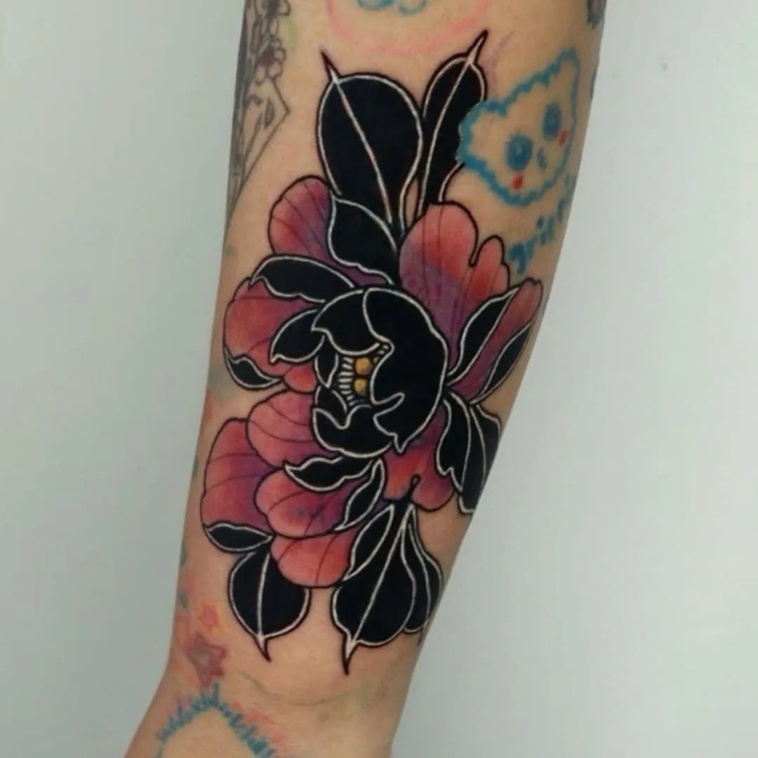 Tattoo of a black and pink flower on an arm