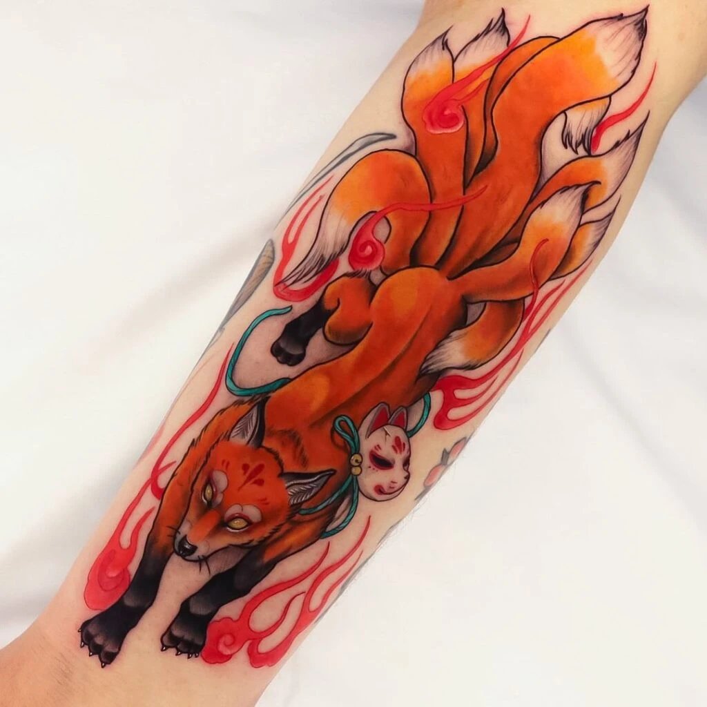 Intricate tattoo of a fox with nine tails and a mask