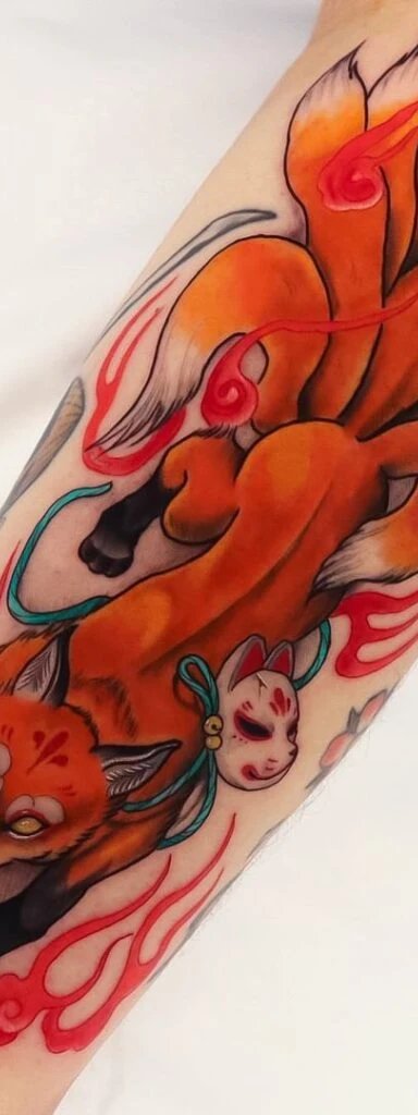 Intricate tattoo of a fox with nine tails and a mask