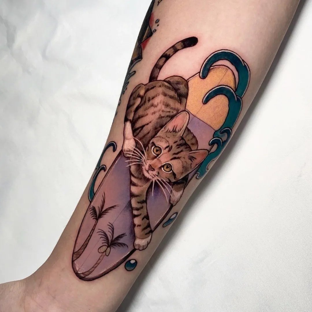 A detailed tattoo of a cat on a forearm.