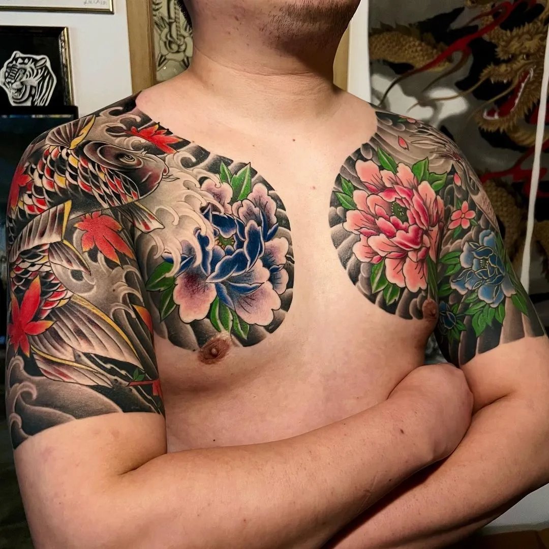Man with intricate tattooed sleeves showcasing flowers and motifs.