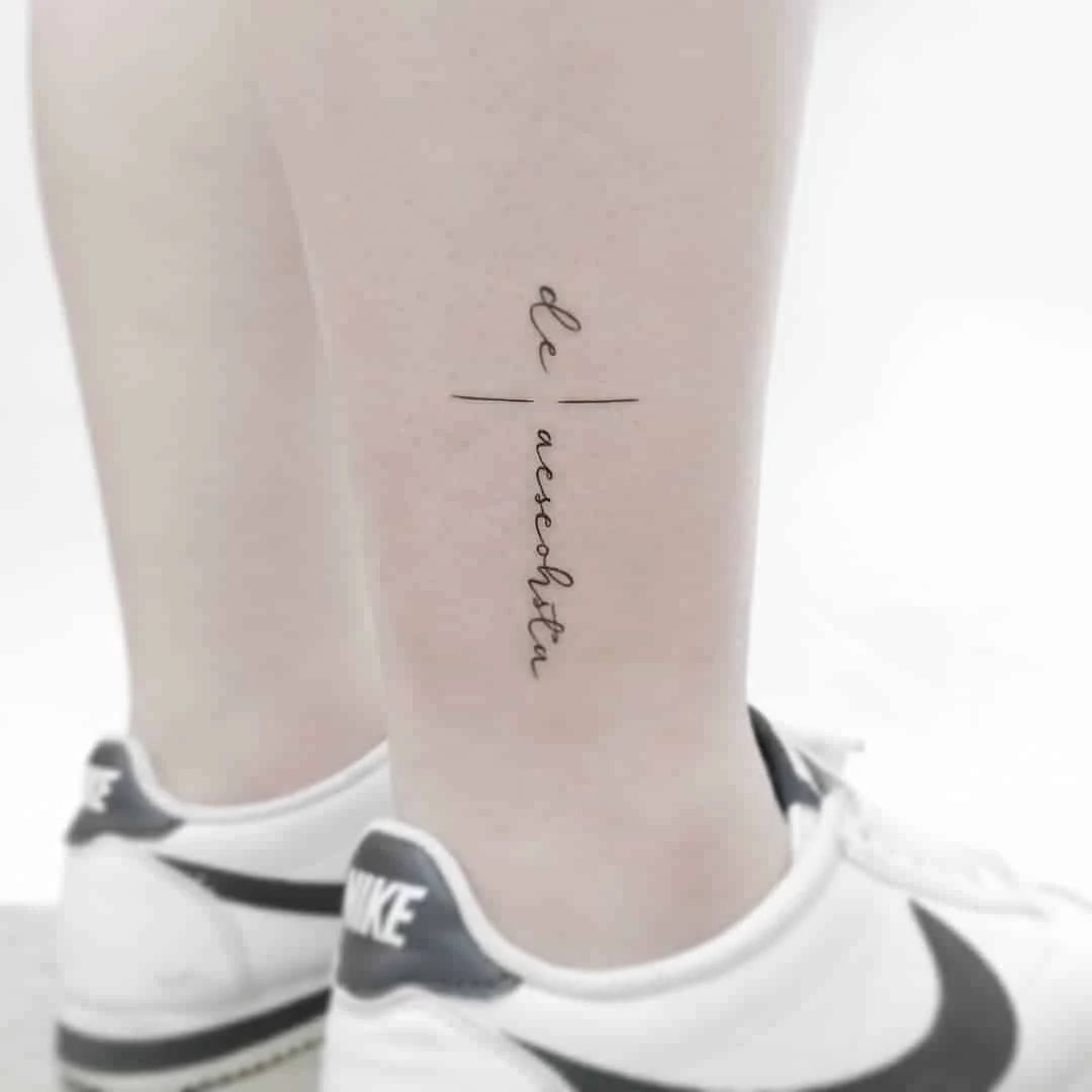 Minimalist tattoo on calf with script text