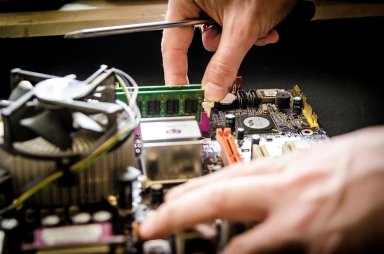 Technician upgrading computer hardware with RAM