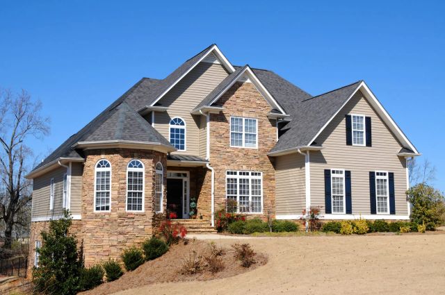 Elegant two-story house with stone and siding exterior.