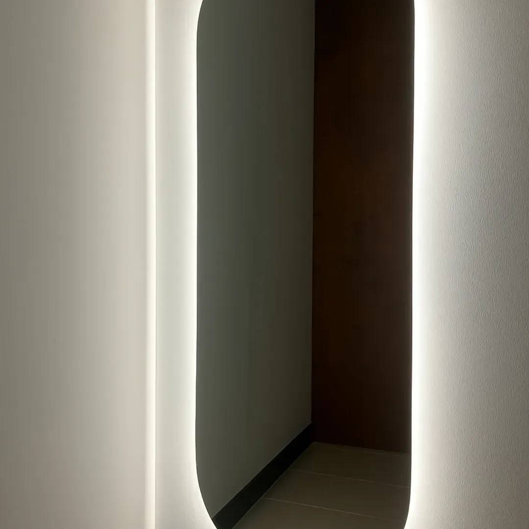 Illuminated mirror in a modern hallway